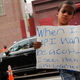 A child holds up a sign outside the Bethel Baptist Church before the funeral for Eric Garner on July 23, 2014, in New York City.